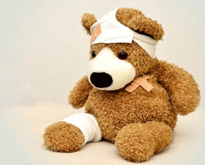 A teddy bear is patched up as if from a first-aid class.